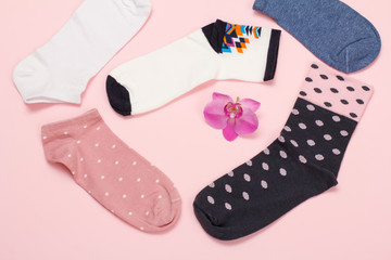 Color women socks on a pink background.