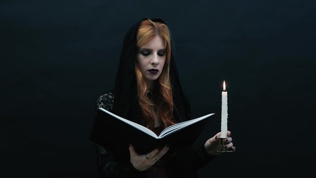 Gothic witch with book and candle