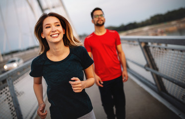 Healthy sporty young people jogging and running outdoors