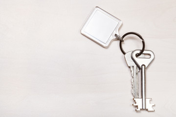 bundle of keys on ring with blank white keychain