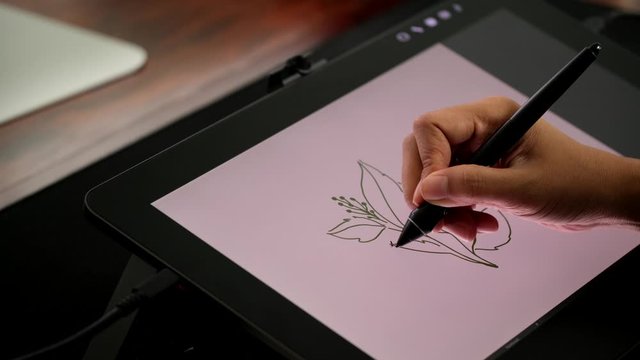 Graphic designer working with creative  pen display. 