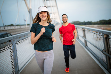 Obraz premium Fitness, sport, people, exercising and lifestyle concept. Couple running outdoor