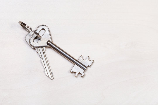 Door Keys On Keyring On Pale Brown Table