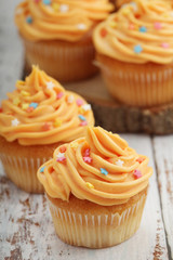 Cupcakes with orange icing on top