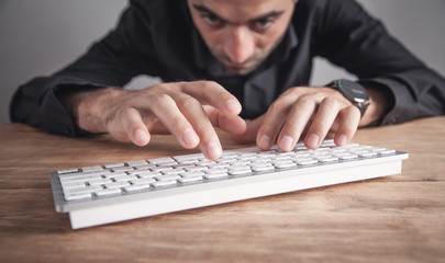 Businessman typing on computer keyboard.