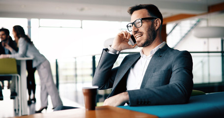 Inspired businesman sitting at coffee-break