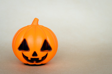 Halloween pumpkin on neutral background. Holiday card, festive banner. Layout, template with text space.