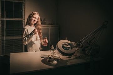 teenager girl standing in a chemistry classroom