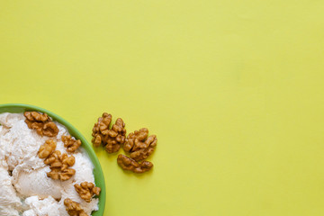 Ice cream with walnut on green plate.