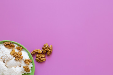 Obraz na płótnie Canvas Ice cream with walnut, pink background.