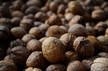 Natural walnut background pattern texture Abstract walnuts heap pattern background Blurred edges frame Natural food in-shell nuts walnuts