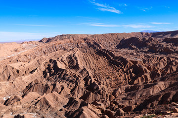 Fototapeta na wymiar Northern Chile - San Pedro de Atacama and surrounding area - Valle de la Luna or Moon valley - this red rock landscape complete with sand dunes looks like a moon landing at sunset with red orange blue