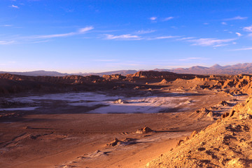 Northern Chile - San Pedro de Atacama and surrounding area - Valle de la Luna or Moon valley - this red rock landscape complete with sand dunes looks like a moon landing at sunset with red orange blue