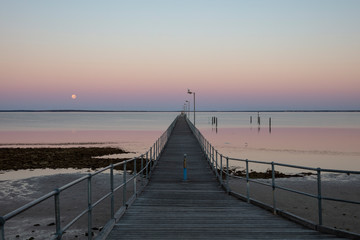 Fototapeta na wymiar The moon and pier at Ceduna in South Australia at dawn