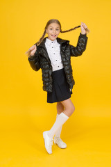 Warm clothing. Fall autumn winter. Fancy little child. Fashion shop. Cute girl wear black jacket on yellow background. Fashion concept. Buy clothes for school season. Schoolgirl fashion outfit