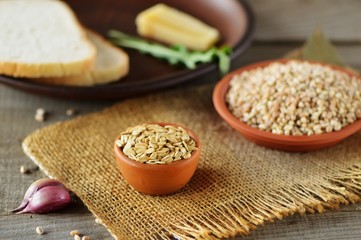 Wheat grain in dishes on the table.grains and wheat ears on a wooden table, top view