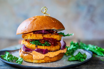 Vegan pumpkin burger with harrisa hummus and chicory