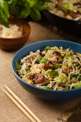 Fried veal, with rice, Chinese cabbage and mushrooms. Sprinkled with sesame and soy sauce.