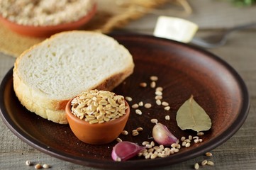 Wheat grain in dishes on the table.grains and wheat ears on a wooden table, top view