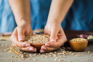 woman hands holding grain in hands