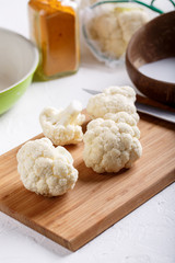 Turmeric and coconut milk baked cauliflower, vegetable recipe. Vegetarian or vegan diet, healthy food concept.