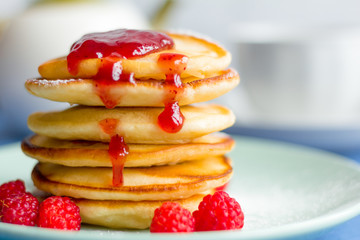 Pancakes with berries and raspberry jam, close-up