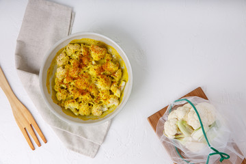 Turmeric and coconut milk baked cauliflower, vegetable recipe. Vegetarian or vegan diet, healthy food concept.