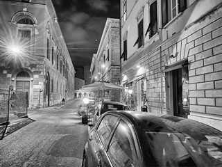 PISA, ITALY - SEPTEMBER 27, 2019: City streets with tourists at night