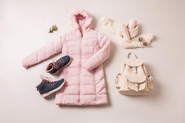 Obraz na płótnie Canvas Winter outfit for women - pastel pink down jacket and accessories.