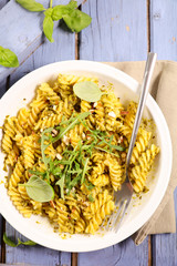 pasta with pesto sauce and basil