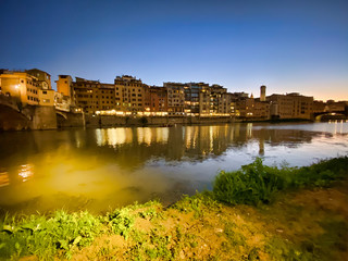 Fototapeta premium Old Bridge and Florence Lungarni at night. Panoramic cityscape in Autumn, Tuscany - Italy