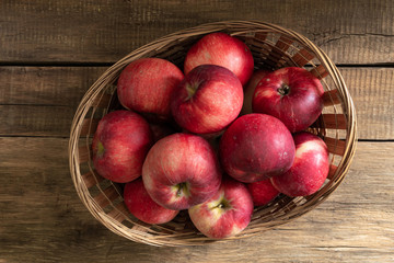 Apples lie on wooden planks, ripe red fruits