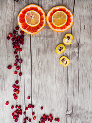 grapefruits, lemon, cydonia slices, red cranberries, top view. Natural vitamins and antioxidants food concept.