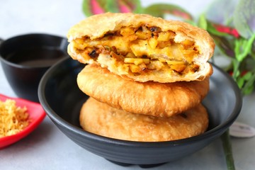 Shegaon or Rajasthani Kachori served with tamarind Chutney and sev.  Kachori or Kachodi is a spicy fried snack from India stuffed with spicy potatoes and onion mixture.