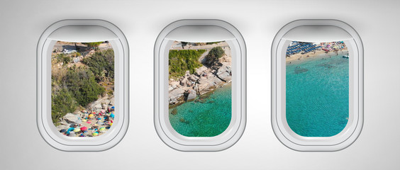 Airplane interior with window view of Elba Island Beach. Concept of travel and air transportation