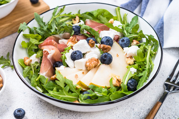Green salad with leaves, fruit and jamon.