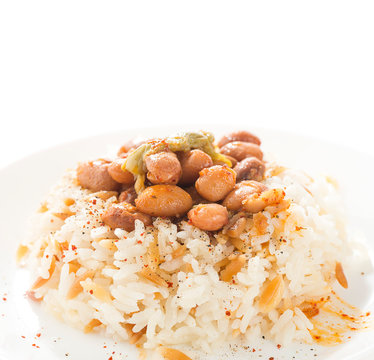 Traditional Turkish food called Kuru fasulye pilav close-up.       