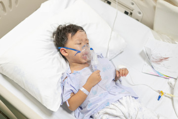 A patient boy is sick flu, He has difficulty breathing Therefore, a doctor giving medicine by a mask.