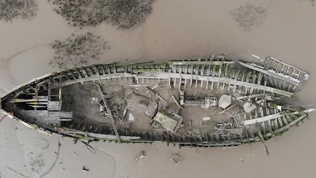 ship wreck from above slowly rising upwards with exposed wood and metal