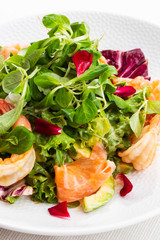 Healthy Salad. Recipe for fresh seafood. Grilled shrimps, prawns, fresh salad lettuce and avocado slices. Healthy Eating. White background. Vertical photo.