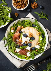 Green salad with leaves, fruit and jamon.