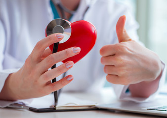 Doctor checking up heart in medical concept
