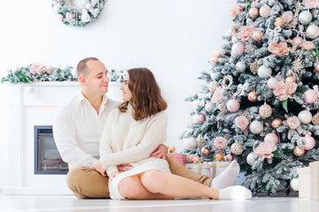 guy and girl look at each other and sit by the fireplace and Chr