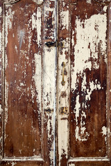 Old cupboard with cracked painted doors, texture of weathered cracked paint
