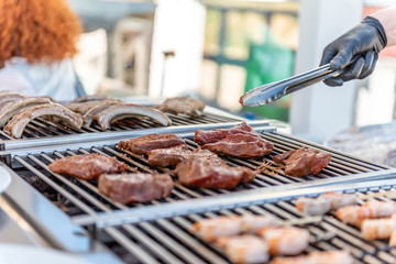 Grilling steaks on a barbecue on a summer night at a restaurant