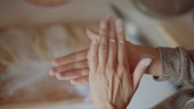 closeup hands of unrecognizable woman rolling dough for baking pies