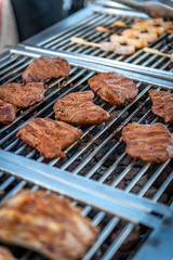 Grilling steaks on a barbecue on a summer night at a restaurant