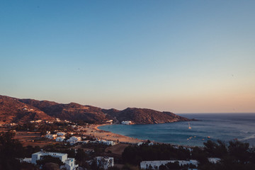 Obraz premium The beautiful island town of Ios, Greece at sunset. Arid and dry landscape with amazing beaches at sunset. 