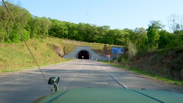 View from the windshield of a car. The car travels along the Narva Tunnel - the first environmental tunnel in Russia.