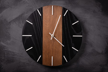wall wooden clock at gray background texture